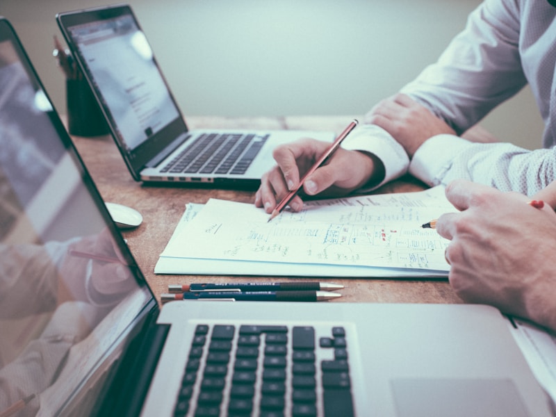 Analyst reviewing audit documents at a desk
